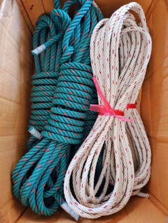 close up of rolled green and white nylon and red dot rope on a wooden backgroundの写真素材