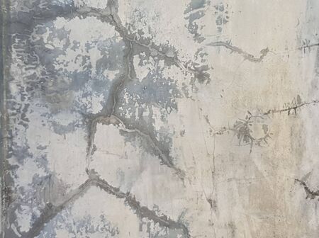 Old aged White and Gray painted Concrete Wall background Texture with some cracksの写真素材