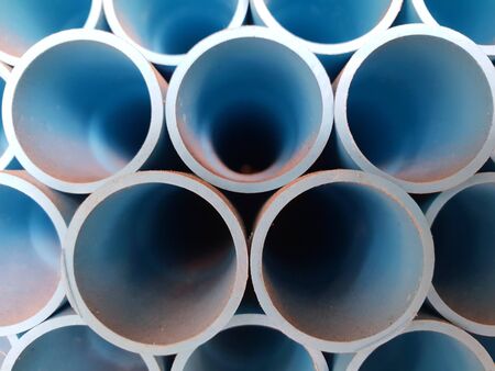 close up of pile of blue water pvc pipe wrench in a container