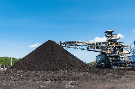 Coal Storage or Coal Stockpile for Power Plant with blue sky in the background.