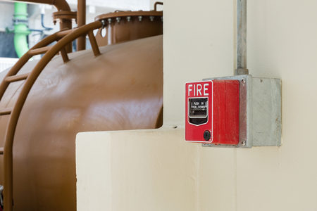 Fire Alarm or Fire Manual Call Point equipment in red box on the cement wall for warning, alert and sign to evacuation alarm building by exit passage way before Rescue Team attack the fire fighting.の写真素材