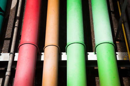 Colorful industrial piping or pipelines. Industrial process piping, valves, fitting, flanges at refinery manufacturing, oil plant or power plant transfer gas, water in the blue sky background.の写真素材