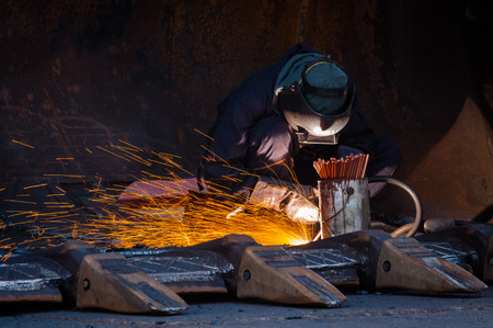 Industrial Worker labourer or welder at the Manufacturing factory welding metal or steel structure....