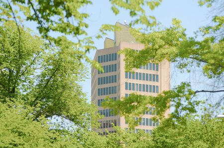 Office high rise seen through trees