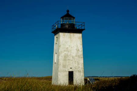 Rustic Lighthouse on Blue Sky Backgroundの写真素材