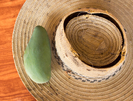 Mango on the old straw hatの写真素材