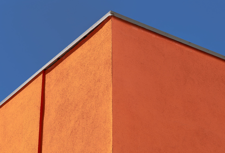Facade plaster background. Single-ply monolithic plaster decorative background. Single layer scraped cement plaster wallpaper. Exterior building structure backdrop.の写真素材
