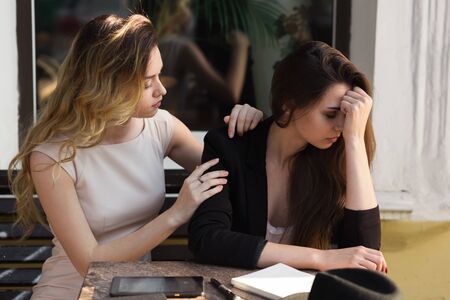 A friend calms a distressed friend because of a recent setbackの写真素材