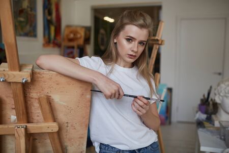 A young artist creates her first sketches with a brushの写真素材