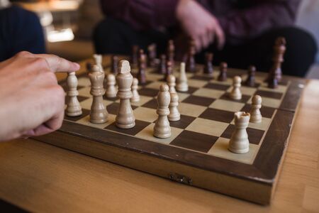 Men play chess in a stylish loft cafe with a modern designの写真素材