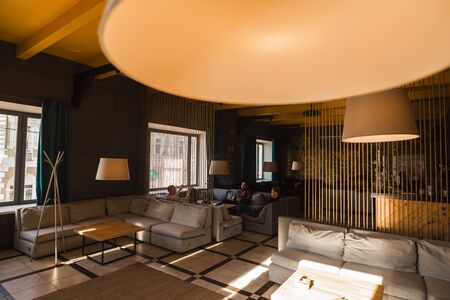 Men relax and smoke hookah in a stylish loft cafe with a modern designの写真素材