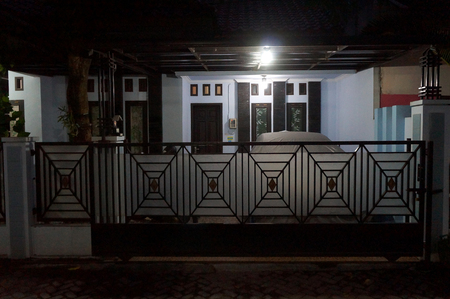 photo of a house front view  with gate over night scene background