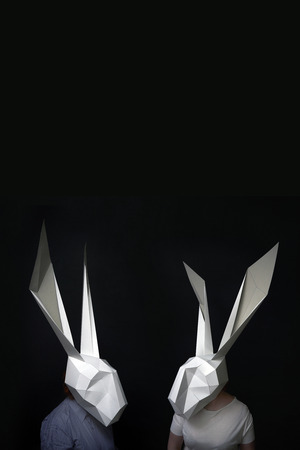 Happy valentines rabbits in geonetric mask against blackboradの写真素材