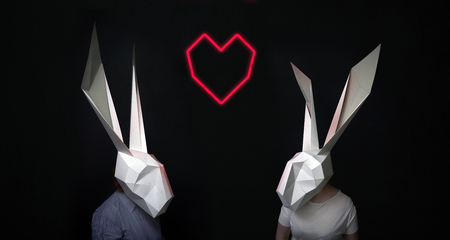 Happy valentines rabbits love story in heart light  on black backgroundの写真素材