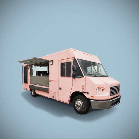 Pink fast food truck on light blue background, template with copy spaceの写真素材