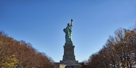 Back of Statue of Liberty on pedestal in autumn coloursの写真素材