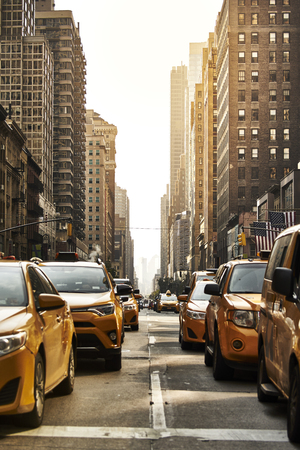 Yellow cabs in rush hours on the street of New York in warm light.のeditorial素材