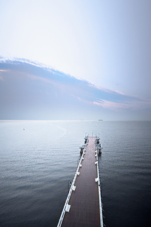 Aerial view of wooden pier at sea shoreの写真素材