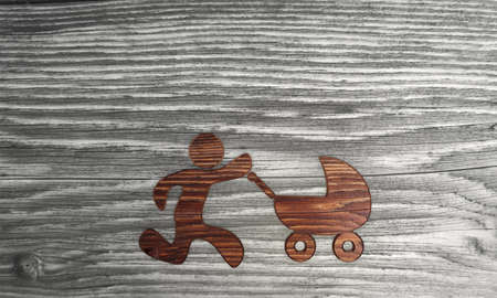3D graphic Isolated baby buggy symbol in a wooden textured  backgroundの写真素材