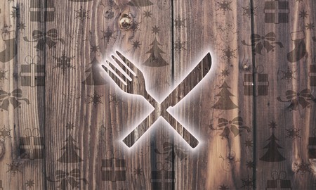 luxury wooden restaurant label on wood with burned in christmas symbols such as snowflakes presents and starsの写真素材