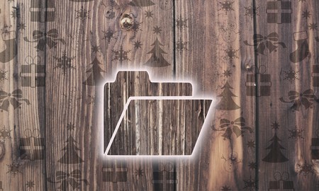 decorative wooden folder label on wood with burned in christmas symbols such as snowflakes presents and starsの写真素材