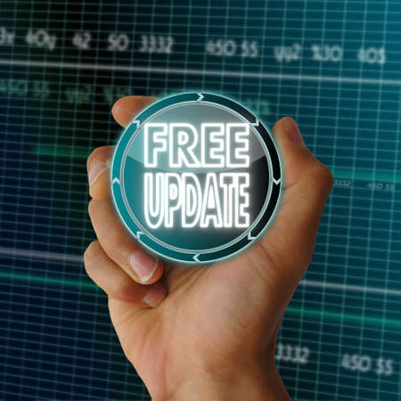 a hand presents future round button with a free update icon on it in front of a electronic data...