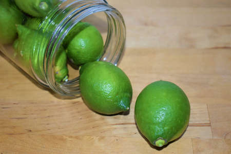 Green lemons out of a jarの写真素材