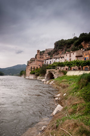 Magnificent Ebro river in the distance reflecting the Miravet castle on top of the hillの写真素材