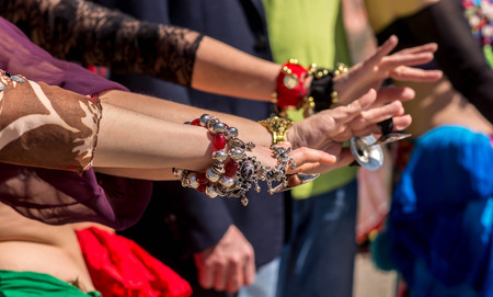 Many dancer?,'s hands together showing unity before going dancing. Public outdoor ethnic dancing show on a sunny dayの写真素材