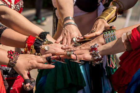 Many dancer?,'s hands together showing unity before going dancing. Public outdoor ethnic dancing show on a sunny dayの写真素材