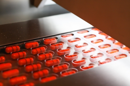 Capsules packed in blister in tablet packing machineの写真素材