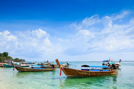 Wooden boats on the beach with the blue sky and seaの写真素材