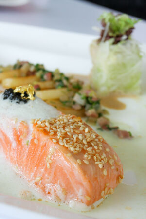 Salmon steak with cream sauce and potatoの写真素材