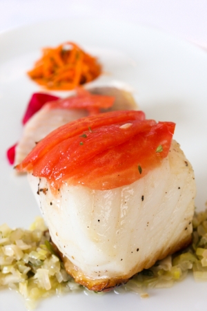 Grilled fillet of seabass with side dishesの写真素材