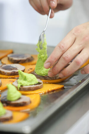 Close up of chef decorating sauce for appetizer 