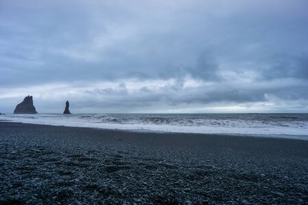 Iceland - Black beach of Vik at rough weather in the eveningの写真素材