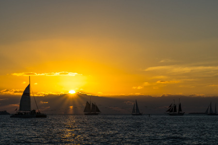 USA, Florida, Spectacular sunset at key west with many sailboats on the water and orange sky