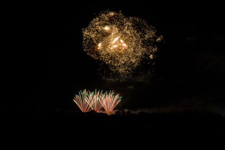 Breathtaking explosion of fireworks looking like a galaxy or milky way in orange coloursの写真素材
