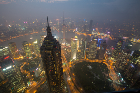 a big asia city by night to the sunrise with all the lights on the streets and skylineのeditorial素材