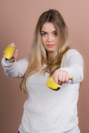 a girl plays with a banana and had funの写真素材