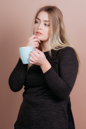 a girl likes to drink a warm cup of coffee and sometimes teaの写真素材