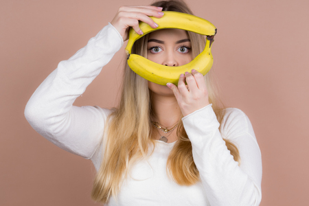 a girl plays with a banana and had funの写真素材
