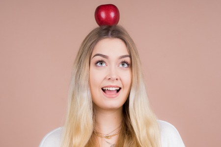 a girl with an apple having funの写真素材