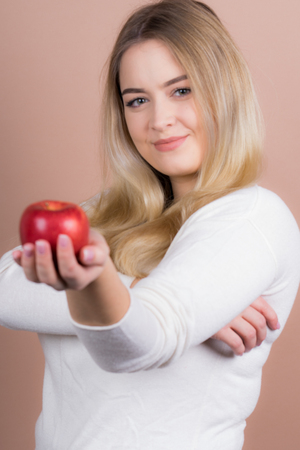a girl with an apple having funの写真素材