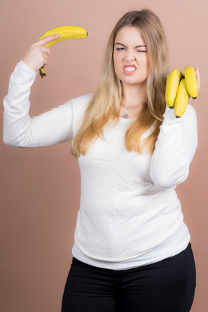 a girl plays with a banana and had funの写真素材