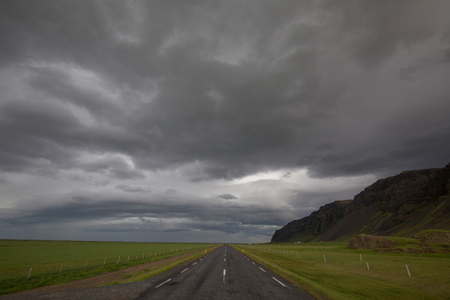 a waterfall in iceland between the mountains from the river springの写真素材