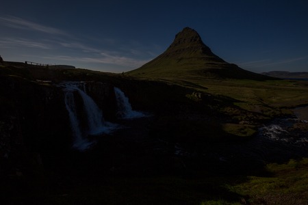 a waterfall in iceland between the mountains from the river springの写真素材
