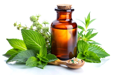Pure Mint Essential Oil in Glass Bottle with Fresh Herbs. Natural Aromatherapy on Clean White Backgroundの写真素材