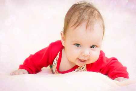 4 months baby girl on a glitter bokeh backgroundの写真素材