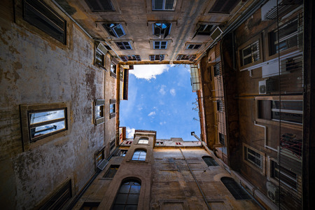 Upward view of a sky from a back alleyの写真素材